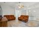 Comfortable living room featuring two sofas and ceiling fan at 4612 Saxonbury Way, Charlotte, NC 28269