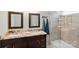 Bathroom featuring double sinks, granite countertop, framed mirrors, and a glass shower at 4612 Saxonbury Way, Charlotte, NC 28269