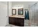 Bathroom with double sinks, granite countertop, framed mirrors, and walk-in shower at 4612 Saxonbury Way, Charlotte, NC 28269