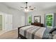 Bedroom showing multiple closets, wood-look flooring, and a ceiling fan at 4612 Saxonbury Way, Charlotte, NC 28269