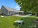 Expansive backyard featuring a pool, patio, and lush green lawn at 5005 Hedgebrook Ln, Waxhaw, NC 28173