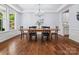 Traditional dining room features hardwood floors, a chandelier, and a large window providing natural light at 5005 Hedgebrook Ln, Waxhaw, NC 28173