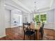 Elegant dining room featuring hardwood floors, a chandelier, and views into the adjacent office space at 5005 Hedgebrook Ln, Waxhaw, NC 28173
