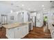 Modern kitchen boasts granite countertops, stainless steel appliances, an island, and ample cabinet space at 5005 Hedgebrook Ln, Waxhaw, NC 28173
