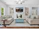 Elegant living room featuring a fireplace, built-in shelves, and comfortable seating at 5005 Hedgebrook Ln, Waxhaw, NC 28173