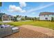 Cozy backyard patio with outdoor seating, surrounded by lush green lawn and neighborhood views at 5114 Whispy Vines Ln, Huntersville, NC 28078