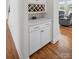 Wet bar featuring custom wine rack, cabinets, and countertop space, perfect for entertaining at 5114 Whispy Vines Ln, Huntersville, NC 28078