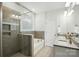 Bathroom featuring a walk-in shower, soaking tub, dual sinks and granite countertops at 5114 Whispy Vines Ln, Huntersville, NC 28078