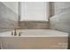 A close-up of the bathroom tub and tiled wall at 5114 Whispy Vines Ln, Huntersville, NC 28078