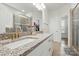 Bathroom featuring dual vanities, granite countertops, framed mirror, and glass enclosed shower at 5114 Whispy Vines Ln, Huntersville, NC 28078