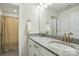 Bathroom featuring granite countertops, dual sinks, and shower with patterned curtain at 5114 Whispy Vines Ln, Huntersville, NC 28078