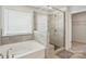 A view of the bathroom with a tub and walk-in shower at 5114 Whispy Vines Ln, Huntersville, NC 28078