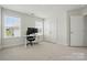 Well-lit room with desk, chair, and double door closet provides ample space for work and storage at 5114 Whispy Vines Ln, Huntersville, NC 28078