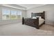 This spacious bedroom features large windows and a statement bed frame at 5114 Whispy Vines Ln, Huntersville, NC 28078