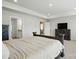 This is a neutral bedroom with a tray ceiling and doors to other rooms at 5114 Whispy Vines Ln, Huntersville, NC 28078