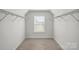A walk-in closet with shelves on either side of a window at 5114 Whispy Vines Ln, Huntersville, NC 28078