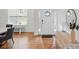 Bright foyer features hardwood floors, a white front door with sidelights, and dining area at 5114 Whispy Vines Ln, Huntersville, NC 28078