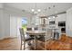 Eat-in kitchen features white cabinets, modern appliances, and hardwood floors, creating a welcoming space at 5114 Whispy Vines Ln, Huntersville, NC 28078