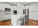 Modern kitchen with a central island, stainless steel appliances, and sleek white countertops for a stylish appeal at 5114 Whispy Vines Ln, Huntersville, NC 28078