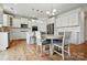 Spacious kitchen offers a stylish dining area, white cabinetry, and modern stainless steel appliances at 5114 Whispy Vines Ln, Huntersville, NC 28078
