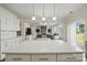 Open concept kitchen featuring a view of the living room with stone fireplace, perfect for entertaining guests at 5114 Whispy Vines Ln, Huntersville, NC 28078