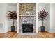 Inviting living room showcasing a stone fireplace and hardwood floors, perfect for cozy evenings at 5114 Whispy Vines Ln, Huntersville, NC 28078