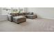 Bright living room with cozy gray sectional sofa and plush carpeting at 5114 Whispy Vines Ln, Huntersville, NC 28078