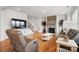Spacious living room with hardwood floors, a stone fireplace, and comfortable leather seating at 5114 Whispy Vines Ln, Huntersville, NC 28078
