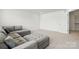 Spacious room with gray sectional sofa and neutral carpeting, ready for your personal touch at 5114 Whispy Vines Ln, Huntersville, NC 28078