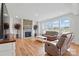 Bright living room with a stone fireplace, hardwood floors, and large windows overlooking neighborhood at 5114 Whispy Vines Ln, Huntersville, NC 28078