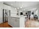 Open layout showcases a seamless transition between the kitchen and living room with a stone fireplace at 5114 Whispy Vines Ln, Huntersville, NC 28078