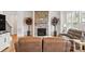 Living room features stone fireplace, hardwood floors, leather seating, and tall green plants at 5114 Whispy Vines Ln, Huntersville, NC 28078