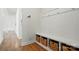 Mudroom area with wainscoting, bench with storage baskets, and hooks at 5114 Whispy Vines Ln, Huntersville, NC 28078
