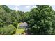 Aerial view of a charming home surrounded by lush trees and a well-manicured yard at 517 Powell St, Rock Hill, SC 29732
