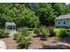 Landscaped backyard featuring a charming wishing well and mature plantings adding to the property's appeal at 517 Powell St, Rock Hill, SC 29732