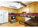 Functional kitchen with wooden cabinets and a classic stove, ready for your culinary creations at 517 Powell St, Rock Hill, SC 29732