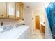 Convenient laundry room with washer, dryer, storage cabinets and adjacent bathroom at 517 Powell St, Rock Hill, SC 29732