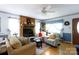 Cozy living room with a wood-burning fireplace and large windows, filled with lots of natural light at 517 Powell St, Rock Hill, SC 29732