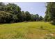 Expansive and well-maintained yard featuring mature trees and manicured lawn, perfect for outdoor activities at 517 Powell St, Rock Hill, SC 29732