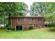 Brick home back exterior features sliding door and large windows, enhancing natural light and outdoor connection at 661 Blackwelder Rd, Statesville, NC 28625