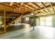 Unfinished basement featuring exposed ceiling, concrete walls, stairs, support beams, and sliding glass door at 661 Blackwelder Rd, Statesville, NC 28625