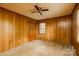Spacious carpeted bedroom with two windows and closet with wood paneled walls and ceiling fan at 661 Blackwelder Rd, Statesville, NC 28625