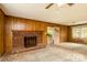 Cozy living room featuring brick fireplace, neutral carpeting, and large windows, offering a warm and inviting space at 661 Blackwelder Rd, Statesville, NC 28625