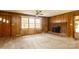 Bright and spacious living room features a cozy fireplace, large windows, and neutral carpet at 661 Blackwelder Rd, Statesville, NC 28625