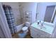 Bathroom with tub and shower, and white sink and vanity at 6919 Ware Rd, Charlotte, NC 28212