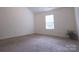 Spacious bedroom with neutral carpet, a large window, and ample natural light creates a relaxing atmosphere at 6919 Ware Rd, Charlotte, NC 28212