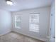 Bedroom featuring carpeted floors, two windows, and white walls at 6919 Ware Rd, Charlotte, NC 28212