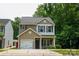 Charming two-story home with a one car garage and a well-manicured lawn at 6919 Ware Rd, Charlotte, NC 28212