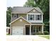 Charming two-story home with a well-maintained front yard and attached garage with black fixtures at 6919 Ware Rd, Charlotte, NC 28212