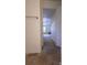 Hallway features tile flooring as you enter, carpet ahead, and neutral paint throughout at 6919 Ware Rd, Charlotte, NC 28212